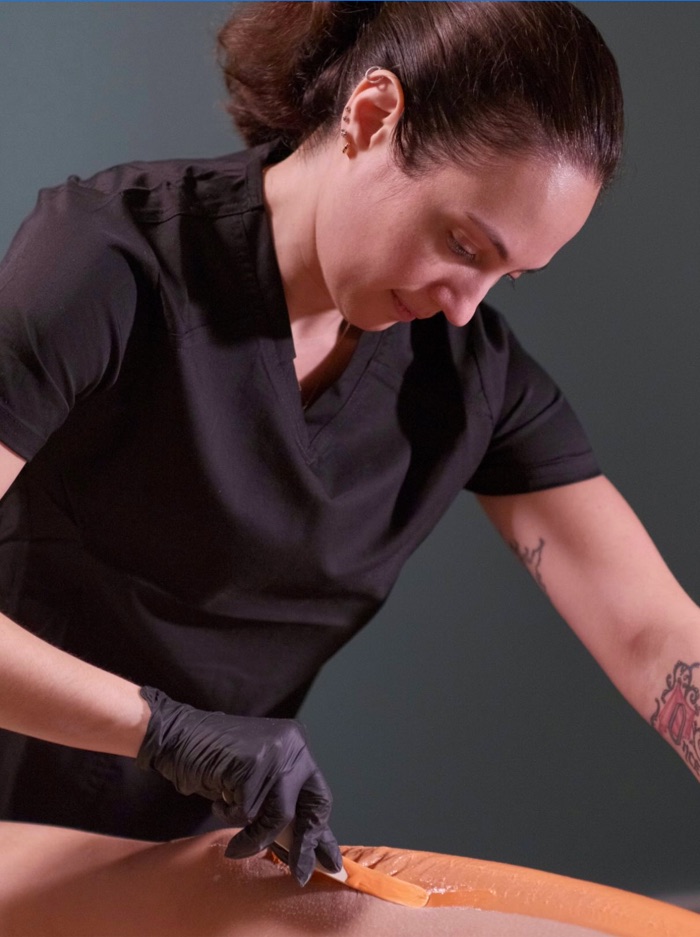 Nicole waxing a client at Bodylogic Spa